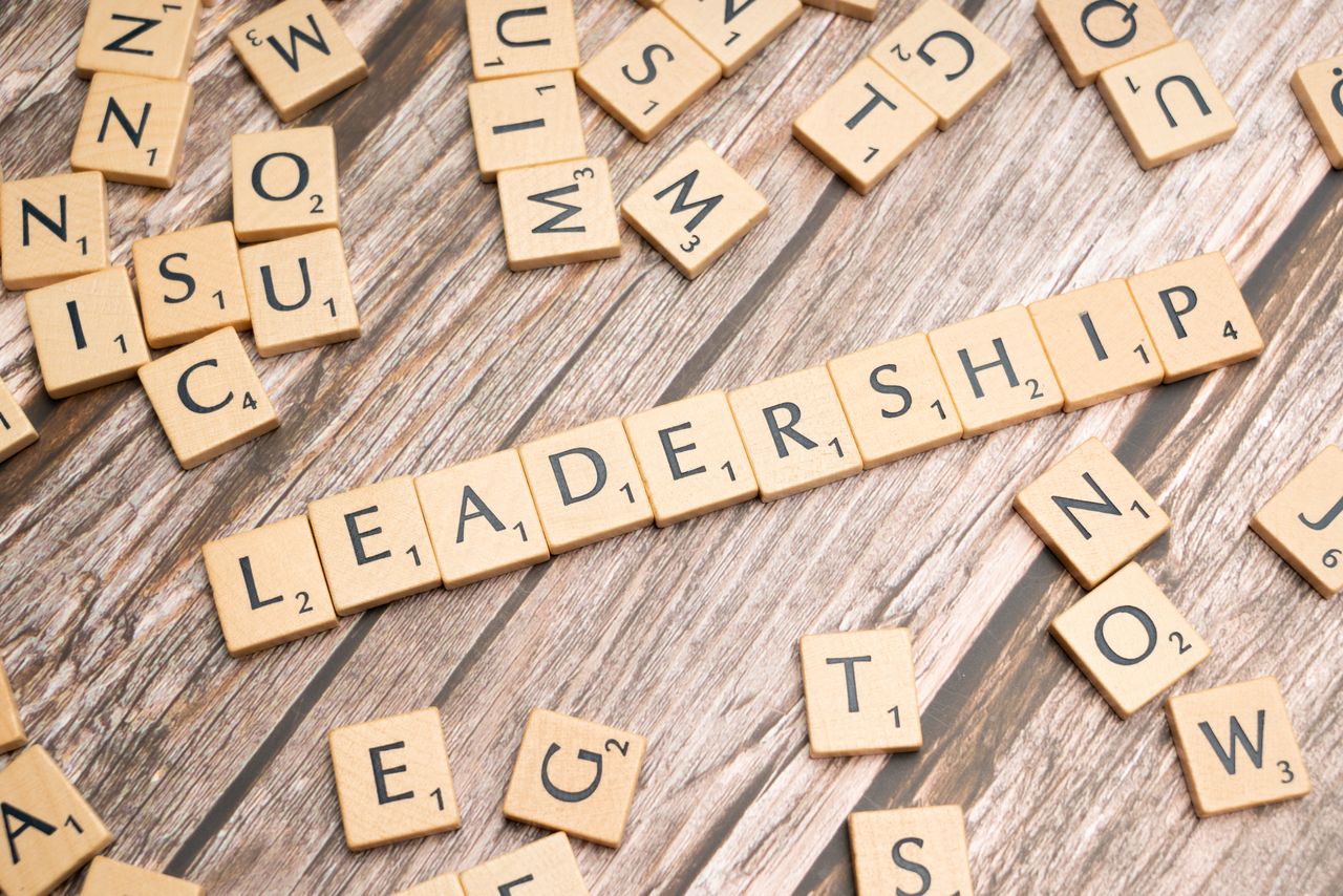 services-04 Wooden letter tiles spelling 'LEADERSHIP' on a wooden surface, symbolizing leadership qualities and skills.