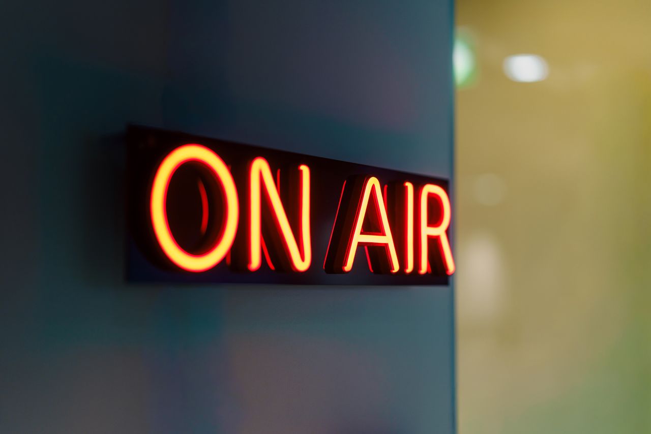 Mastering the First Impression: Your intriguing post title goes here Close-up of a glowing 'On Air' neon sign in a dimly lit studio setting, symbolizing live broadcasting.